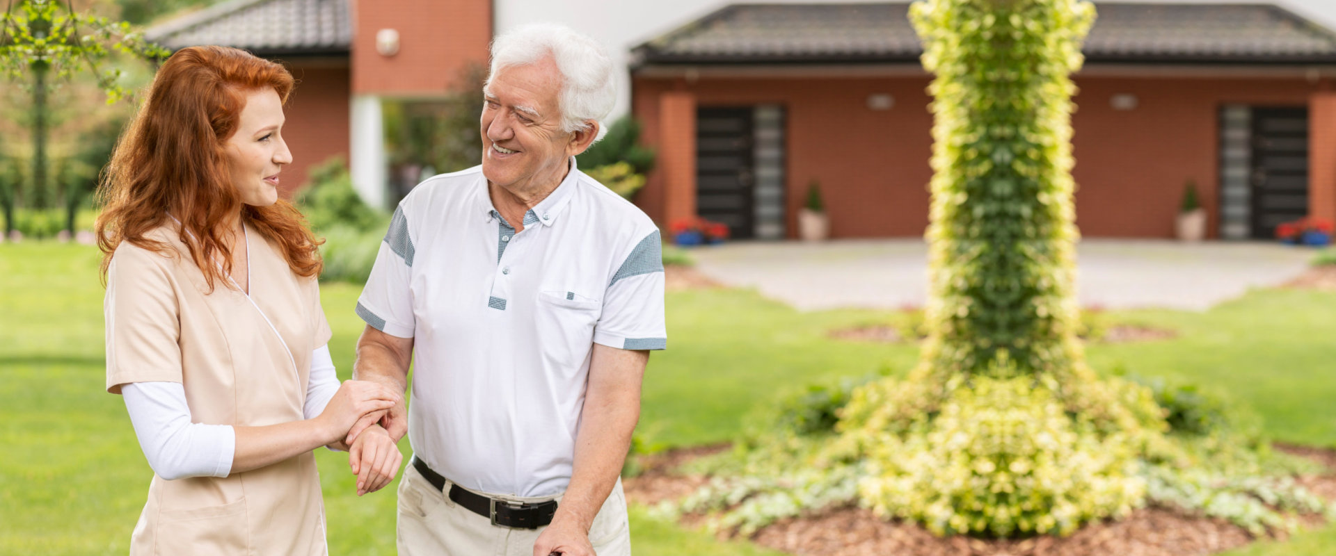 caregiver and senior man smiling