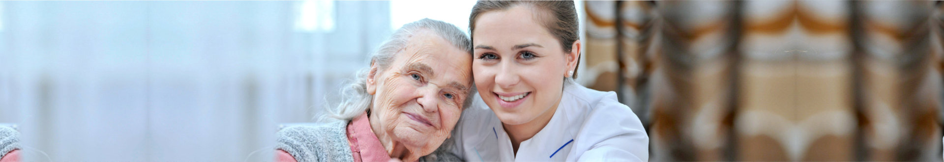 elderly woman with her nurse smiling