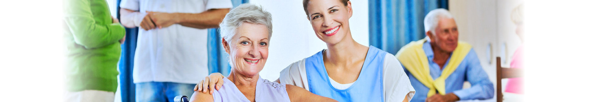 elderly woman and a caregiver smiling